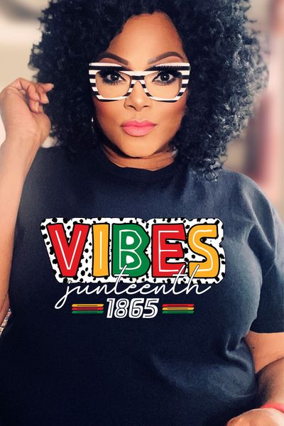 a woman wearing a black shirt with the words vibes written on it