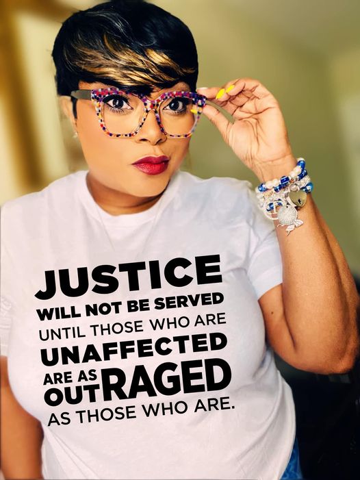 a woman wearing a t - shirt that says justice will not be served until those